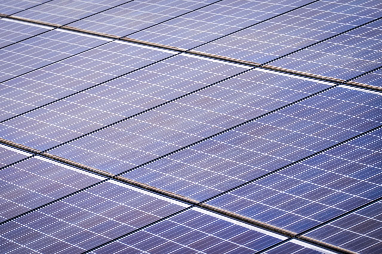 services-01 Close-up of a solar panel array capturing renewable energy on a sunny day.