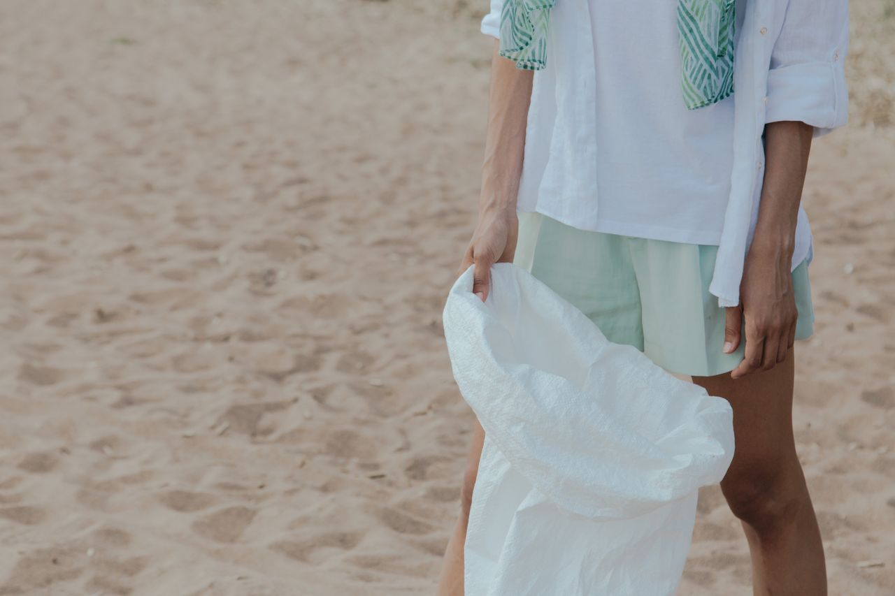 Volunteer holding a sack for eco-friendly beach clean-up activity.